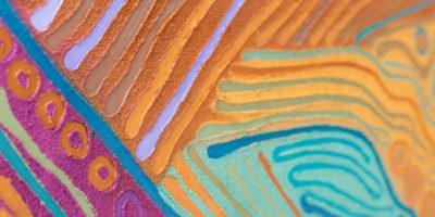 Image of colourful Aboriginal artwork by Aboriginal artist Saretta Fielding. The artwork is titled 'Our Corroboree 2', 2019, mixed media on canvas featuring purple, yellow, orange and green swirl patterns.